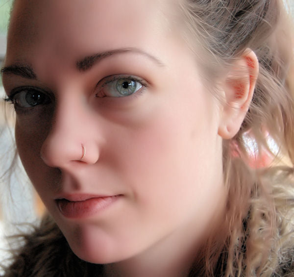 gold twisted nose ring on a model