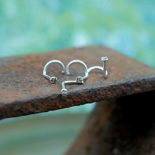 photo of four textured disc nose studs