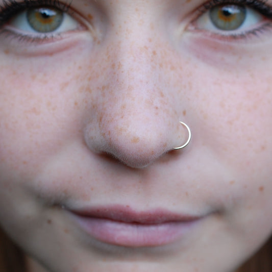 yellow gold nose ring on woman
