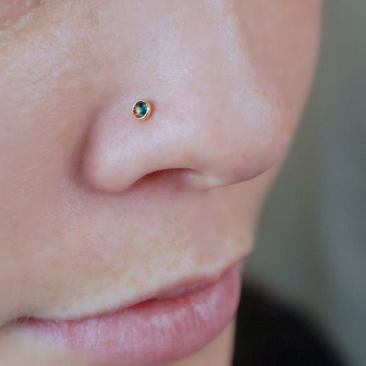 14 karat yellow gold nose jewelry with black opal gemstone