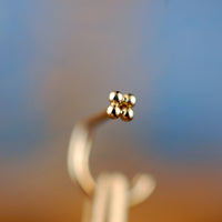 tiny flower nose stud in 14k yellow gold