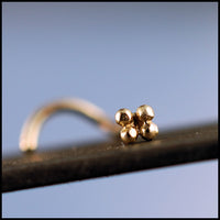 tiny flower nose jewelry in 14k yellow gold