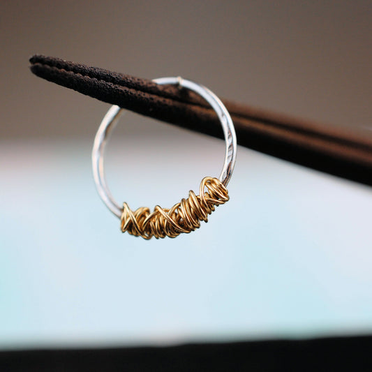 organic silver septum ring with 14 karat yellow gold tangle