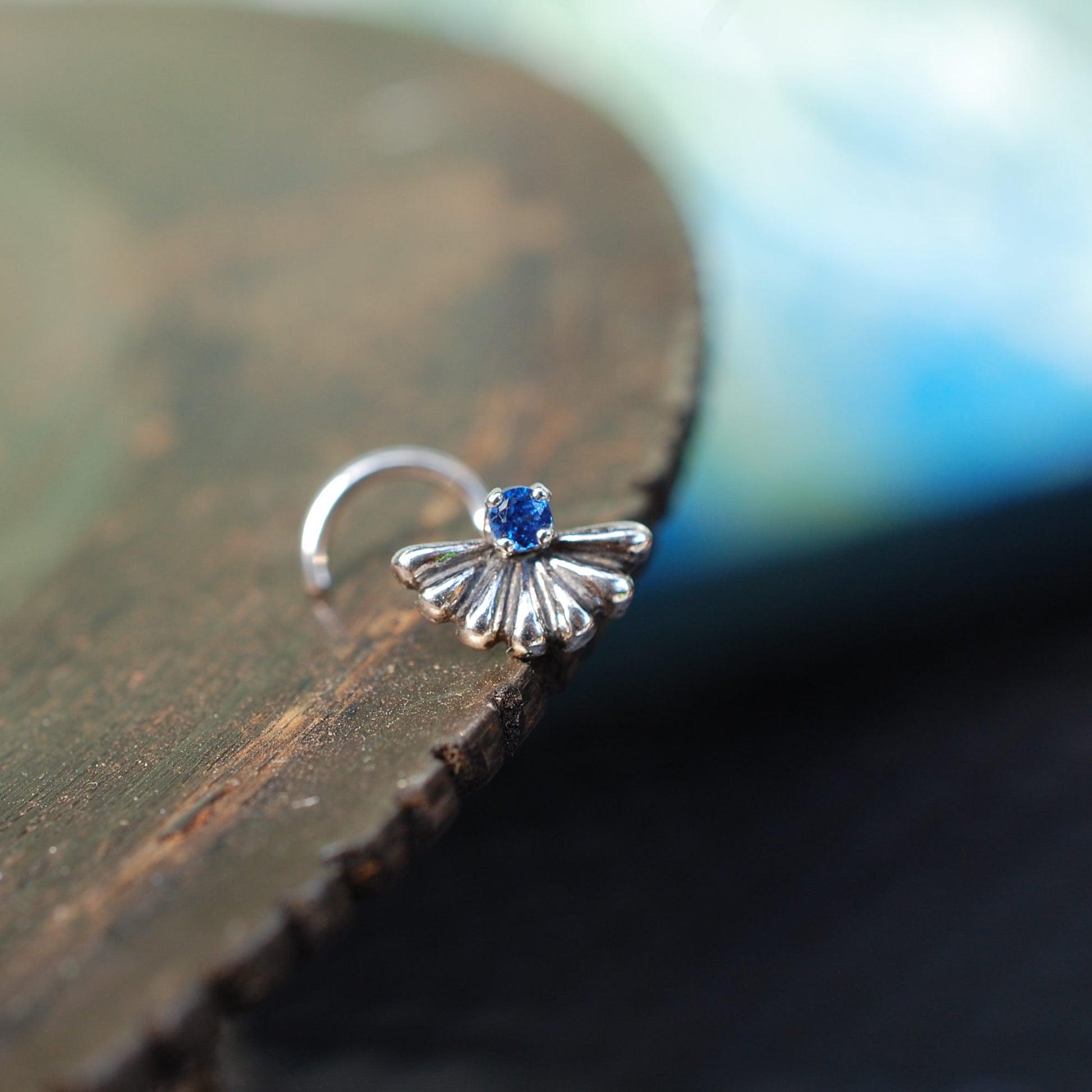 large silver nose stud with sapphire