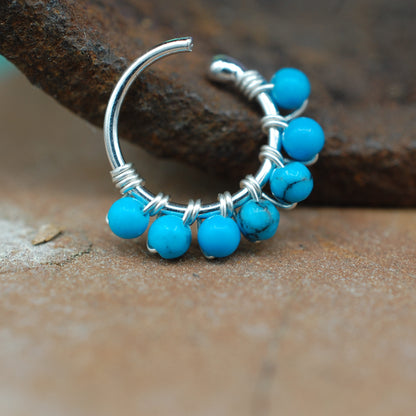 budded silver hoop wrapped in turquoise beads
