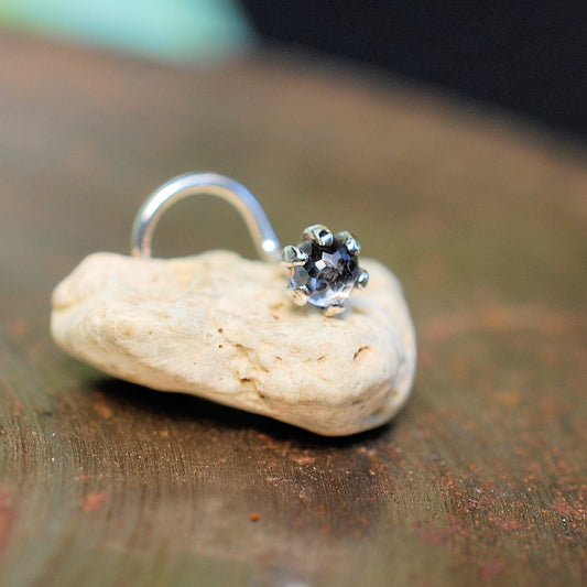 faceted white topaz nose stud on a small rock