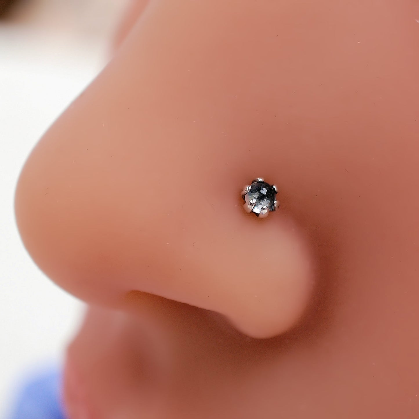 white topaz nose stud on a model