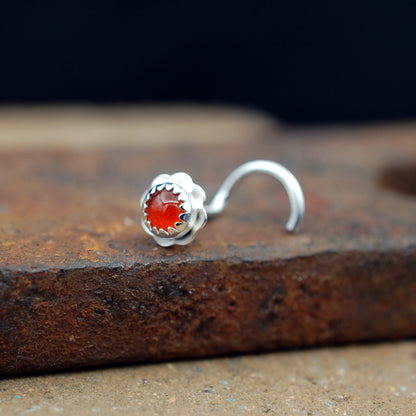 carnelian flower nose stud on a brick
