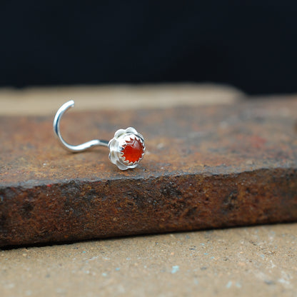 Silver nose stud with orange carnelian stone in a flower setting