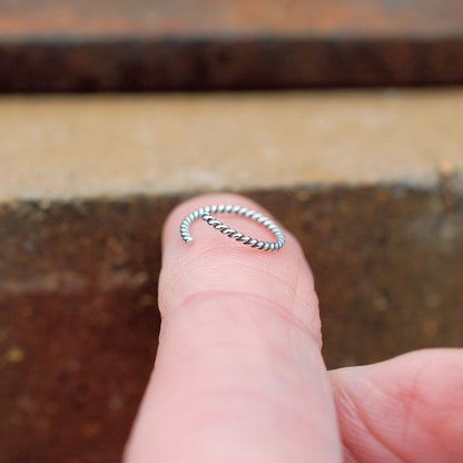silver nose ring show on finger 