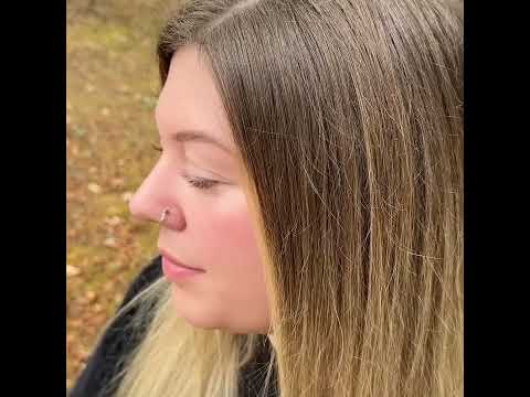 Video of a model wearing a hessonite garnet hammered sterling silver nose ring.