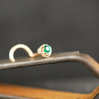 14 karat yellow gold nose stud with dainty emerald