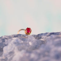 dainty ruby gemstone wrapped in yellow gold nose stud