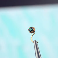dainty gold nose stud with emerald gemstone