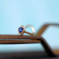 dainty 14 karat gold nose jewelry with sapphire