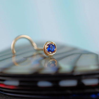 dainty sapphire nose stud in 14 karat yellow gold