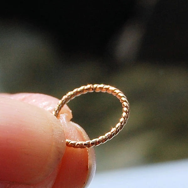 Nose piercing shop with gold wire