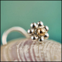 tiny flower nose stud in 14 karat yellow gold