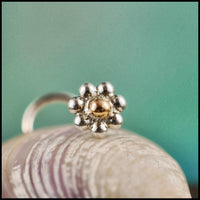 dainty flower nose stud in 14 karat yellow gold